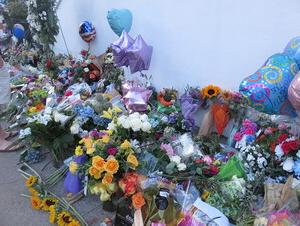 Mourners leave flowers